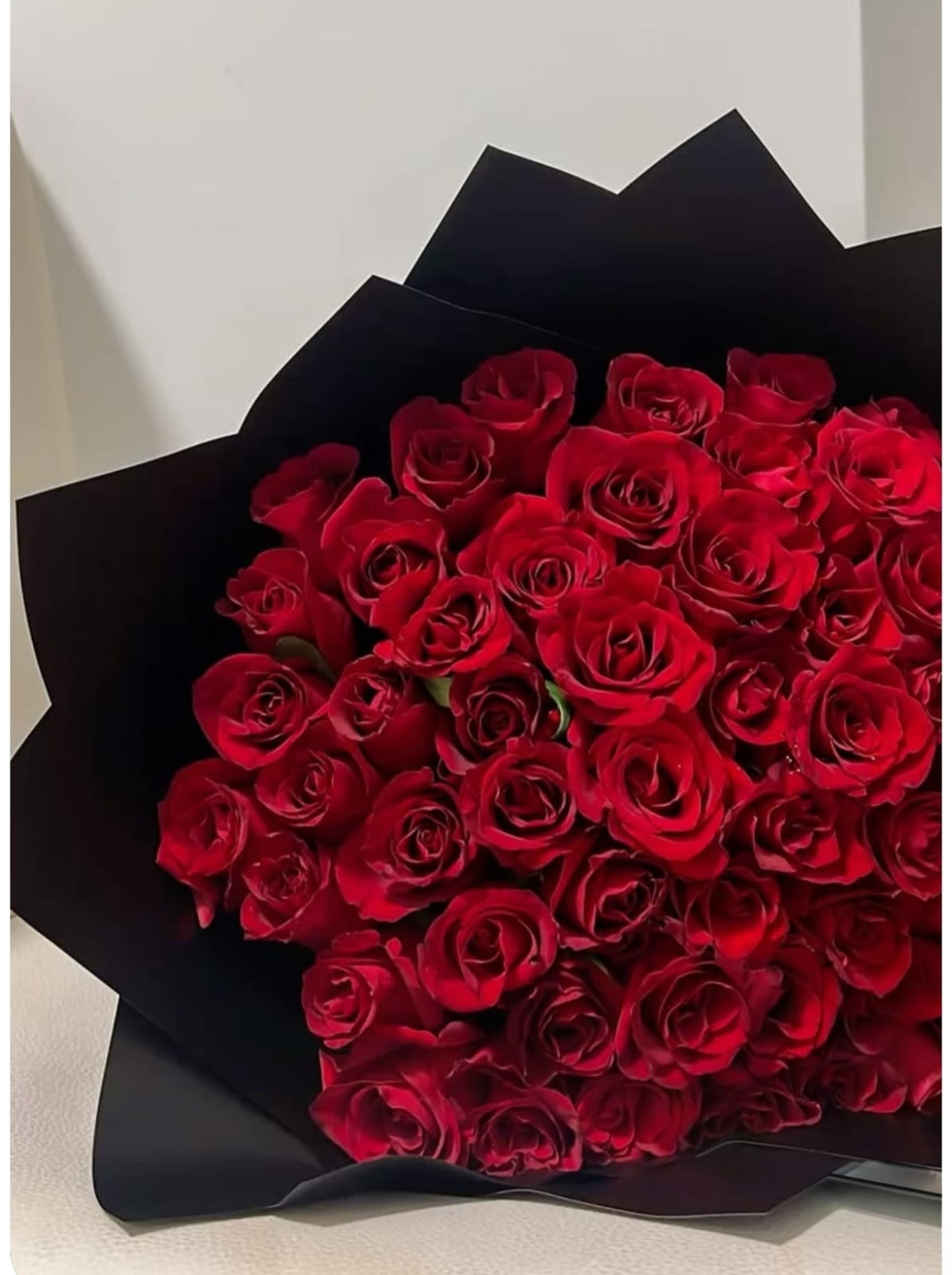 Classic red roses wrapped in black